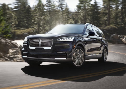 A Lincoln Aviator® SUV is being driven on a winding mountain road | Vision Lincoln in Wahpeton ND