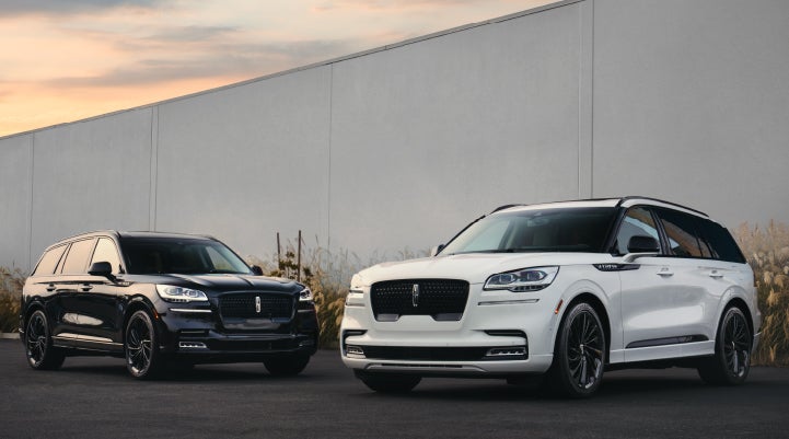 Two Lincoln Aviator® SUVs are shown with the available Jet Appearance Package | Vision Lincoln in Wahpeton ND
