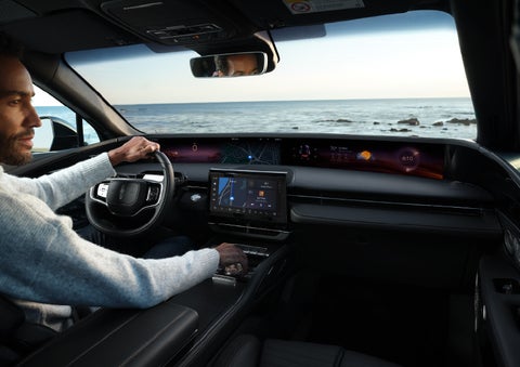 A driver of a parked 2024 Lincoln Nautilus® SUV takes a relaxing moment at a seaside overlook while inside his Nautilus. | Vision Lincoln in Wahpeton ND
